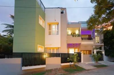 a facade of a house with a green at Like My Apartment in Mysore