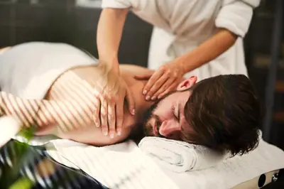 a man getting a massage from a therapist at Port Muziris, A Tribute Portfolio Hotel by Marriott, Kochi Airport in Nedumbassery