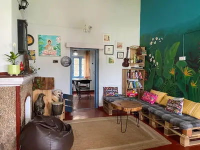 a living room with a couch and a table at The Birdhouse Backpackers Hostel in Coonoor