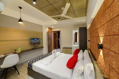 a bedroom with a bed with red pillows on it at Bhavanam Regency Guruvayoor in Guruvāyūr