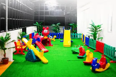 a playground with colorful play equipment in a room at Athirappilly Rainland Resort in Athirappilly