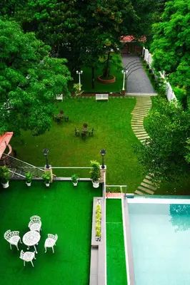 an aerial view of a park with a green lawn at Athirappilly Rainland Resort in Athirappilly