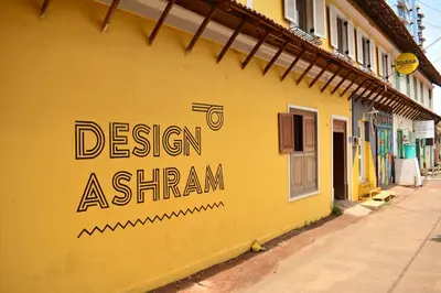 a yellow building with the words design ashtar on it at Design Ashram in Kozhikode