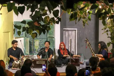 a group of people sitting around a table with instruments at Design Ashram in Kozhikode