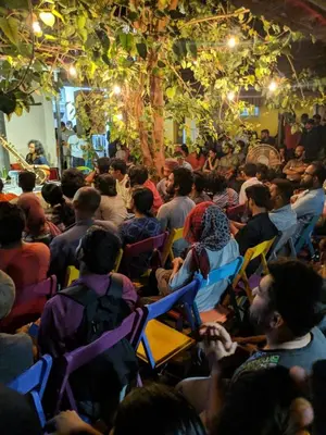 a crowd of people sitting in chairs in a room at Design Ashram in Kozhikode