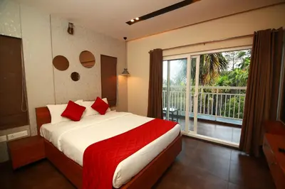 a bedroom with a bed and a large window at Bonita Banasura in Vythiri