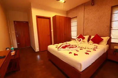a bedroom with a bed with red roses on it at Bonita Banasura in Vythiri