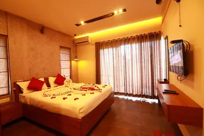 a bedroom with a bed and a large window at Bonita Banasura in Vythiri