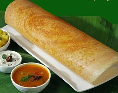 a roll of bread on a plate with a bowl of soup at Twin Tree in Kotagiri