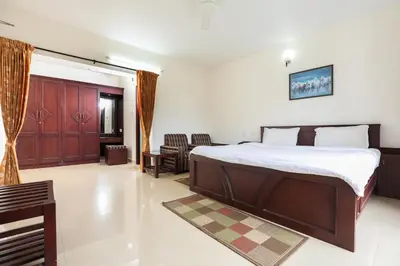 a bedroom with a large bed in a room at Twin Tree in Kotagiri