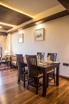 a dining room with a table and chairs at KPM TRIPENTA HOTEL in Kozhikode