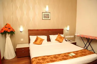 a bedroom with a bed and a vase of flowers at Kallada hotels in Trichūr