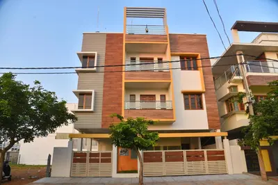 a tall building with a balcony on top of it at Elegant Serviced Apartment in Mysore