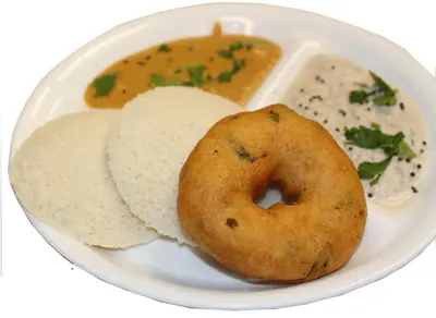 a plate of food with a donut and a bowl of soup at Elegant Serviced Apartment in Mysore