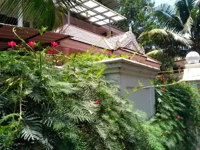 a house with a christmas tree in front of it at Ocean Stay in Nedumbassery