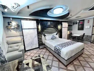 a bedroom with a bed and a couch and a table at Beverly villa in Ooty