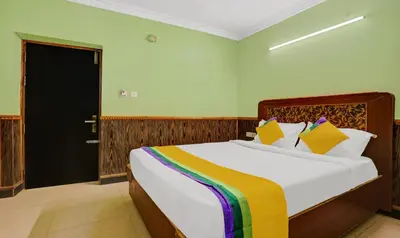 a bedroom with a large bed in a room at Itsy Hotels Rain Forest, 1 km from Rose Garden in Ooty