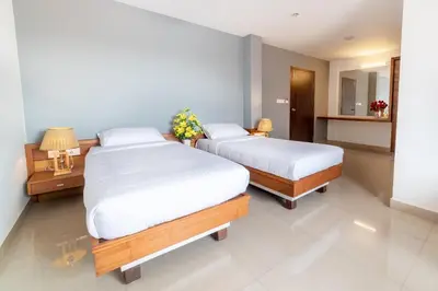 two beds in a room with two beds sidx sidx sidx sidx at Hotel BKM International in Tellicherry