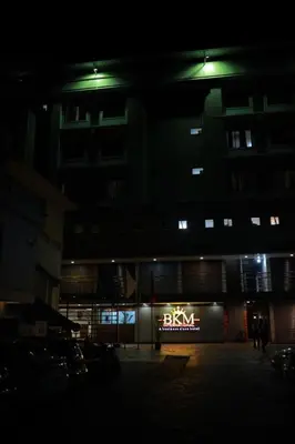 a building with a baxter sign in front of it at night at Hotel BKM International in Tellicherry