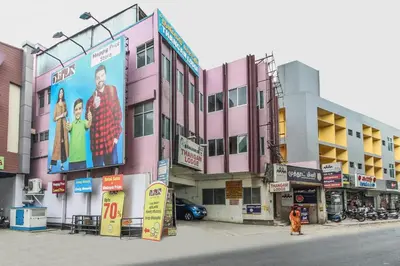 a building with a large billboard on the side of it at SPOT ON Thangam Lodge in Coimbatore