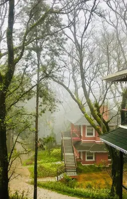 a house in the middle of the woods with a mistyermottermott at Coorg Wilderness Resort & Spa in Madikeri