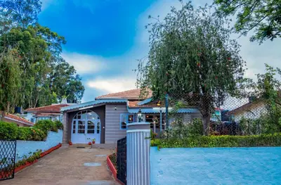a house with a pool in front of it at JJS Cottages in Coonoor