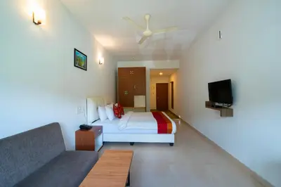 a hotel room with a bed and a couch at The Sanihara Hotel & Resort in Vythiri