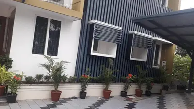 a house with potted plants in front of it at GOLDEN VILLA in Ernakulam