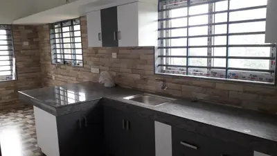 a kitchen with a sink and two windows at GOLDEN VILLA in Ernakulam