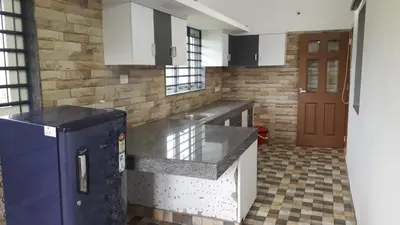 a kitchen with a blue refrigerator in a room at GOLDEN VILLA in Ernakulam