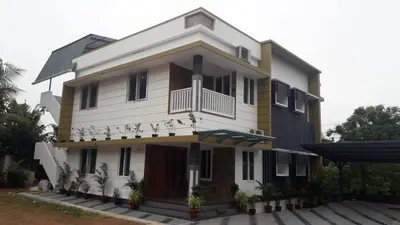 a large white building with a balcony at GOLDEN VILLA in Ernakulam