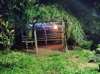 a gate in a forest at night with lights at Family villa .hut in Tariyod