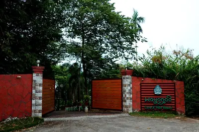 a red gate with a sign on it at Wayanad Cave N Pillar Resort in Sultan Bathery