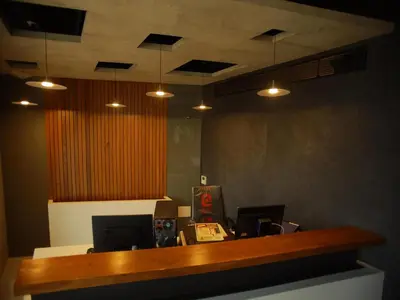 an office with a reception desk with lights at WithInn Hotel - Kannur Airport in Kannur