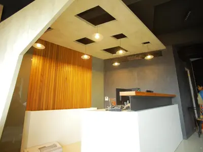 an office with a reception desk and a wooden wall at WithInn Hotel - Kannur Airport in Kannur