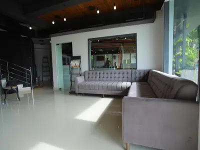a living room with a couch and a table at WithInn Hotel - Kannur Airport in Kannur