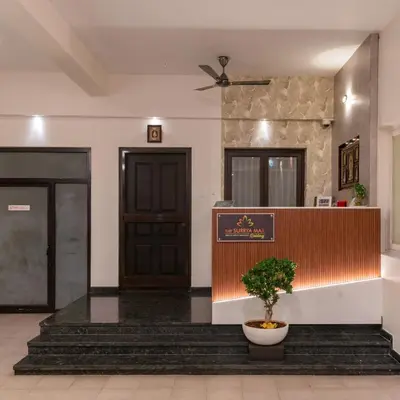 a lobby with a door and a plant in a pot at THE SURRYA MAX RESIDENCY in Pollāchi