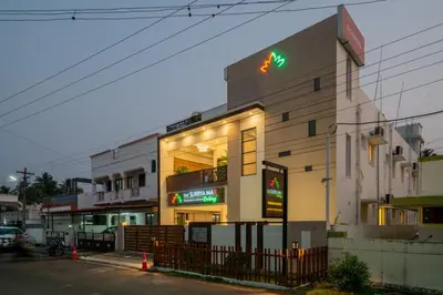 a building with a sign on the side of it at THE SURRYA MAX RESIDENCY in Pollāchi