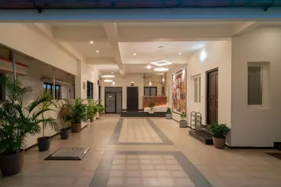 an empty hallway with potted plants in a building at THE SURRYA MAX RESIDENCY in Pollāchi