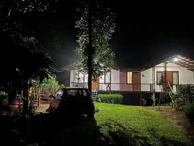 a car parked in front of a house at night at Standard family hut in Tariyod