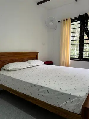 a large bed in a bedroom with a window at Standard family hut in Tariyod