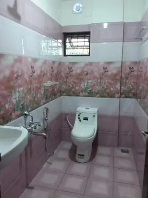 a bathroom with a toilet and a sink at Olive Inn Apartment in Alwaye