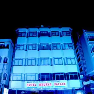 a hotel building with blue lights on it at Hotel Maurya Palace in Mysore