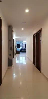 a hallway of a building with white floors and ceilings at KB RESIDENCY in Kozhikode