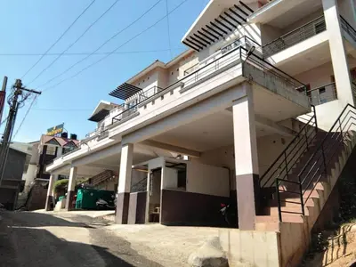 a building with a balcony on the side of it at DEW DROP INN in Ooty