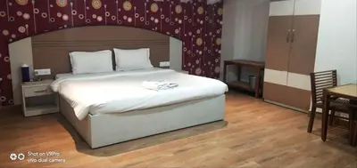 a bedroom with a large white bed in a room at DEW DROP INN in Ooty