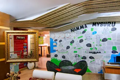 a living room with a couch and a wall with stickers at Aishwarya Residency in Mysore