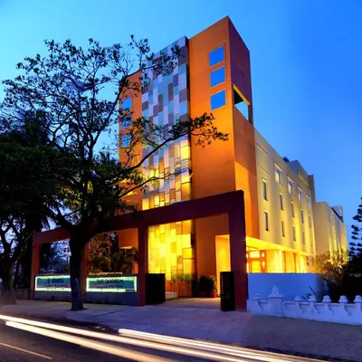 a building with a tree in front of it at The Quorum in Mysore