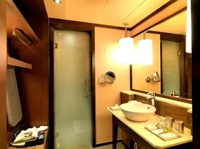 a bathroom with a sink and a mirror at The Quorum in Mysore