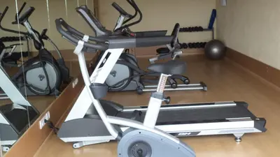 a gym with a treadmill and other exercise equipment at The Quorum in Mysore